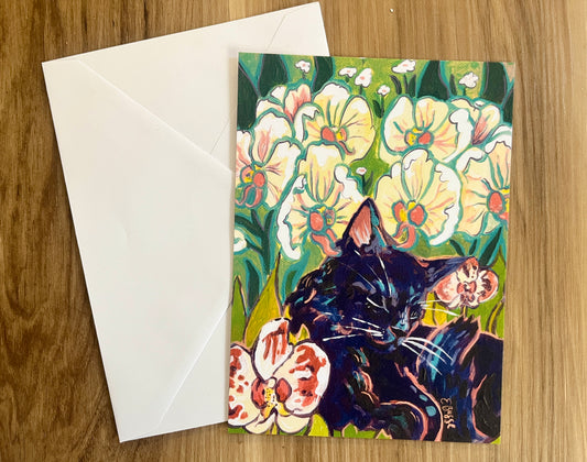 print of the month club postcard and envelopewith a black cat among flowers on a wooden surface