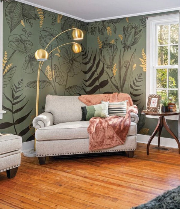 Living room with floral mural, sofa, and wooden floor.