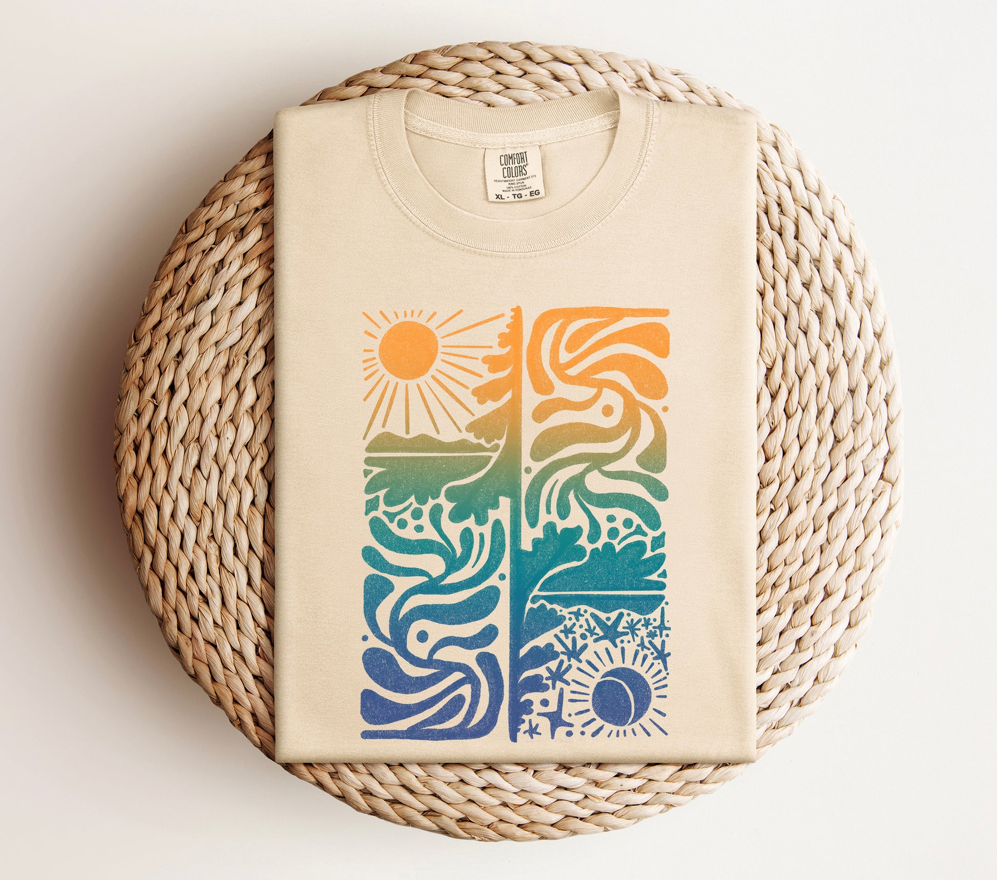 sun and moon colorful hand drawn design by Erika Busse, asheville artist, printed on a comfort colors ivory shirt close up
