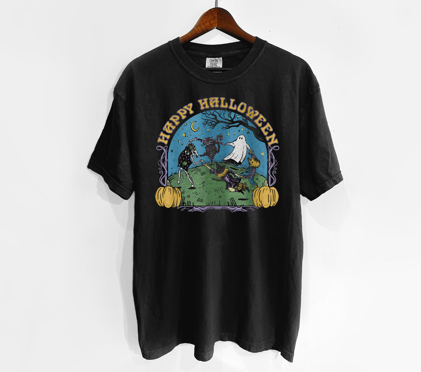 Black t-shirt with Halloween graphic on a hanger against a white background