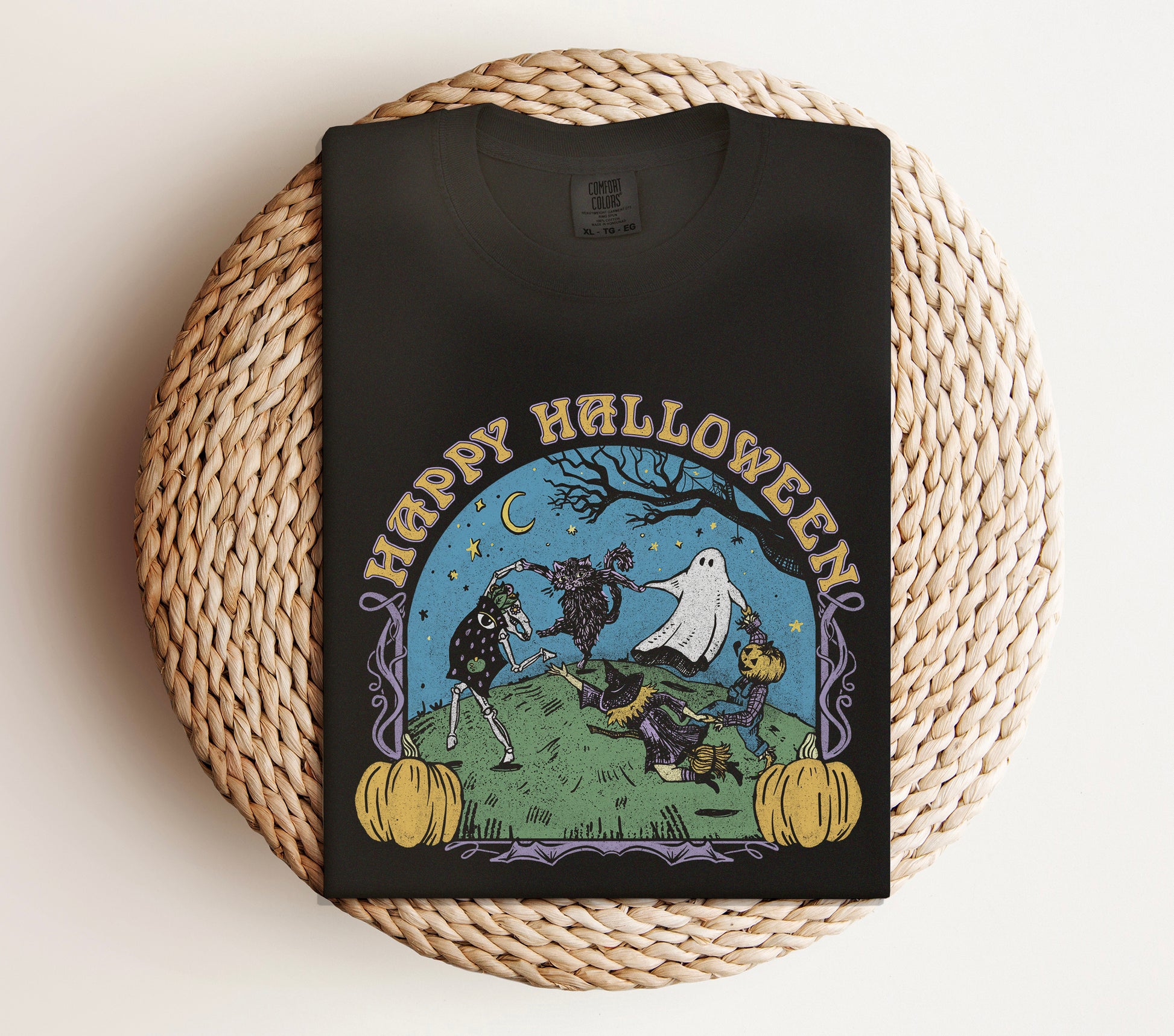 Black t-shirt with Halloween-themed design on a woven mat