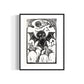 linocut print of a black cat with bat wings surrounded by pumpkins, by asheville artist erika busse in a frame