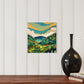 colorful majestic valley acrylic painting by asheville artist erika busse hanging over a table with a vase
