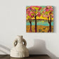 spring trees with pink and limegreen foliage next to a lake at sunset, acrylic painting by asheville artist erika busse. hanging in a room
