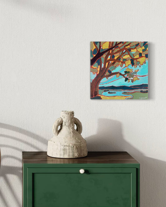 summer tree acrylic painting with a river and mountain landscape by asheville artist erika busse hangin on a wall over a table